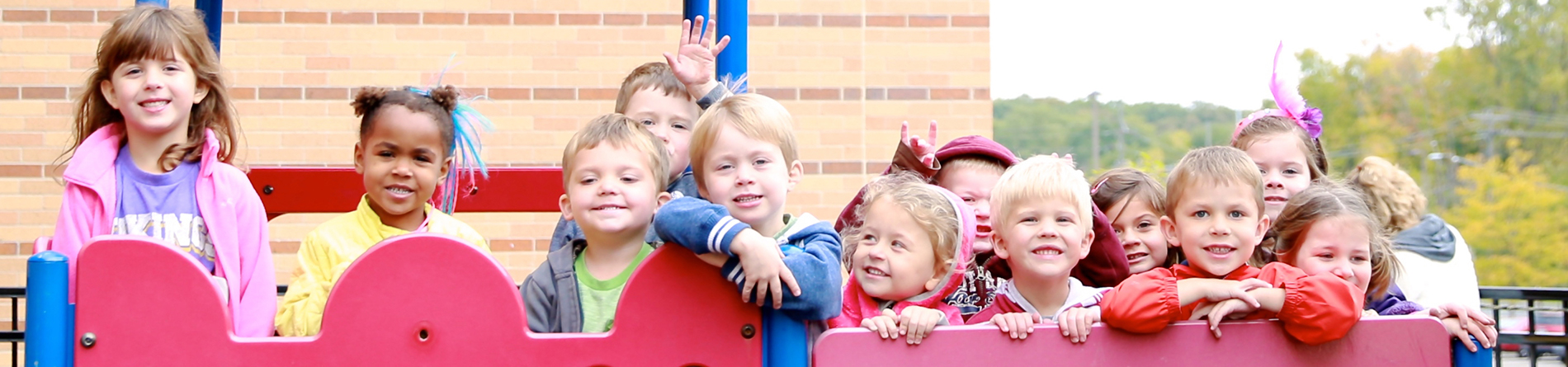 Children in playground smiling